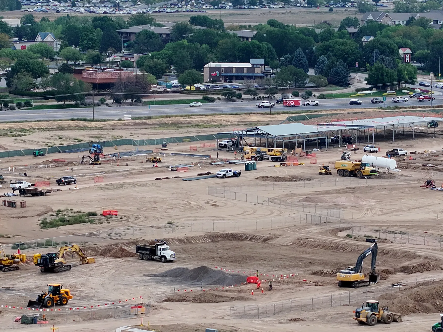 September 15 aerial view of the same steel building and active surrounding site work