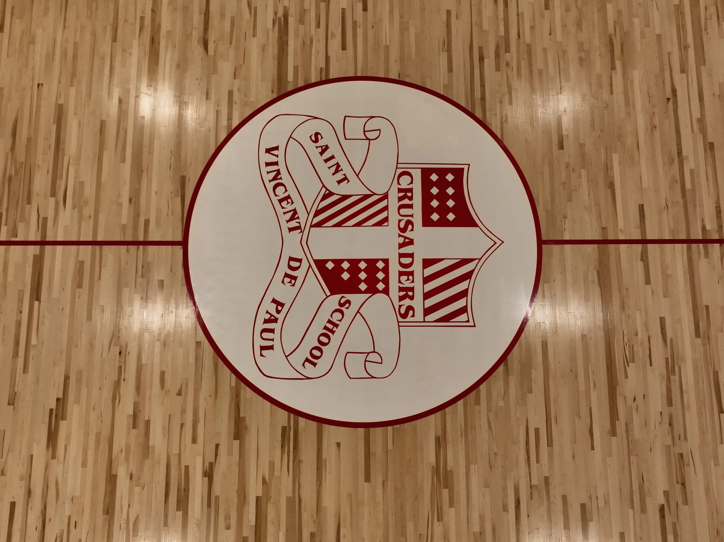 Straight-down detail of the Saint Vincent de Paul School Crusaders center-court crest