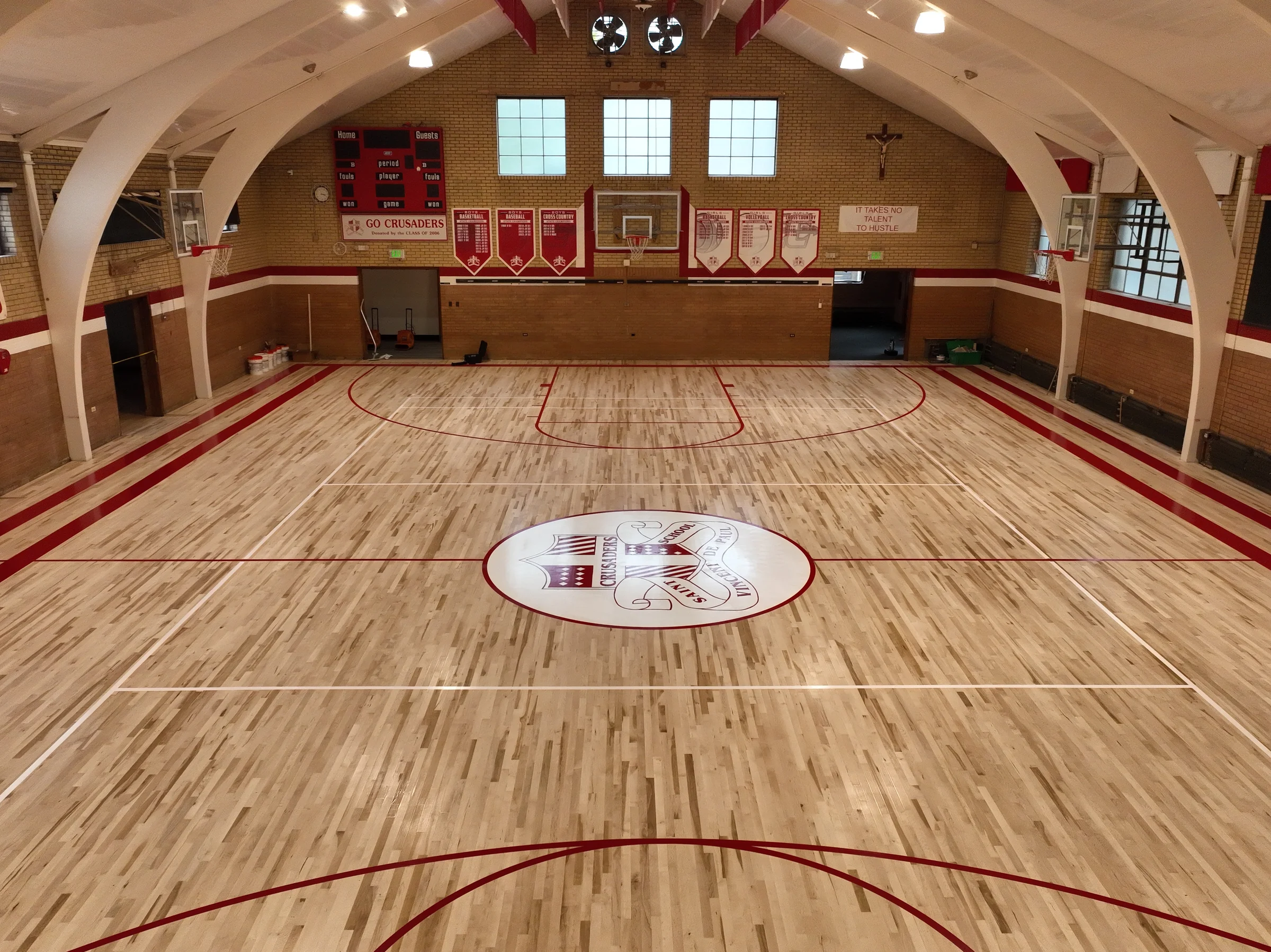 Wide aerial view of the finished gymnasium court from the opposite end