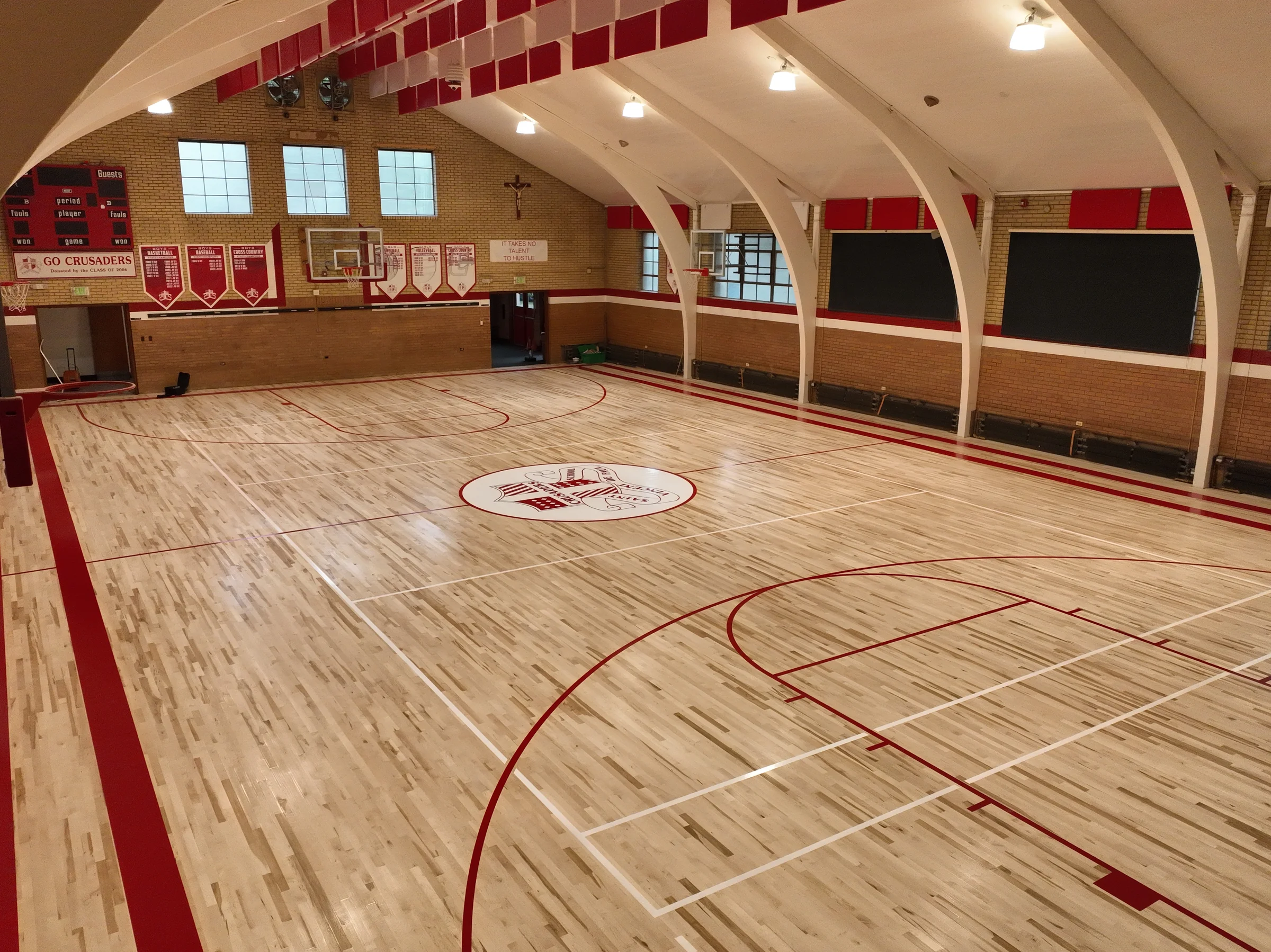 Corner aerial view showing the finished court and gymnasium architecture