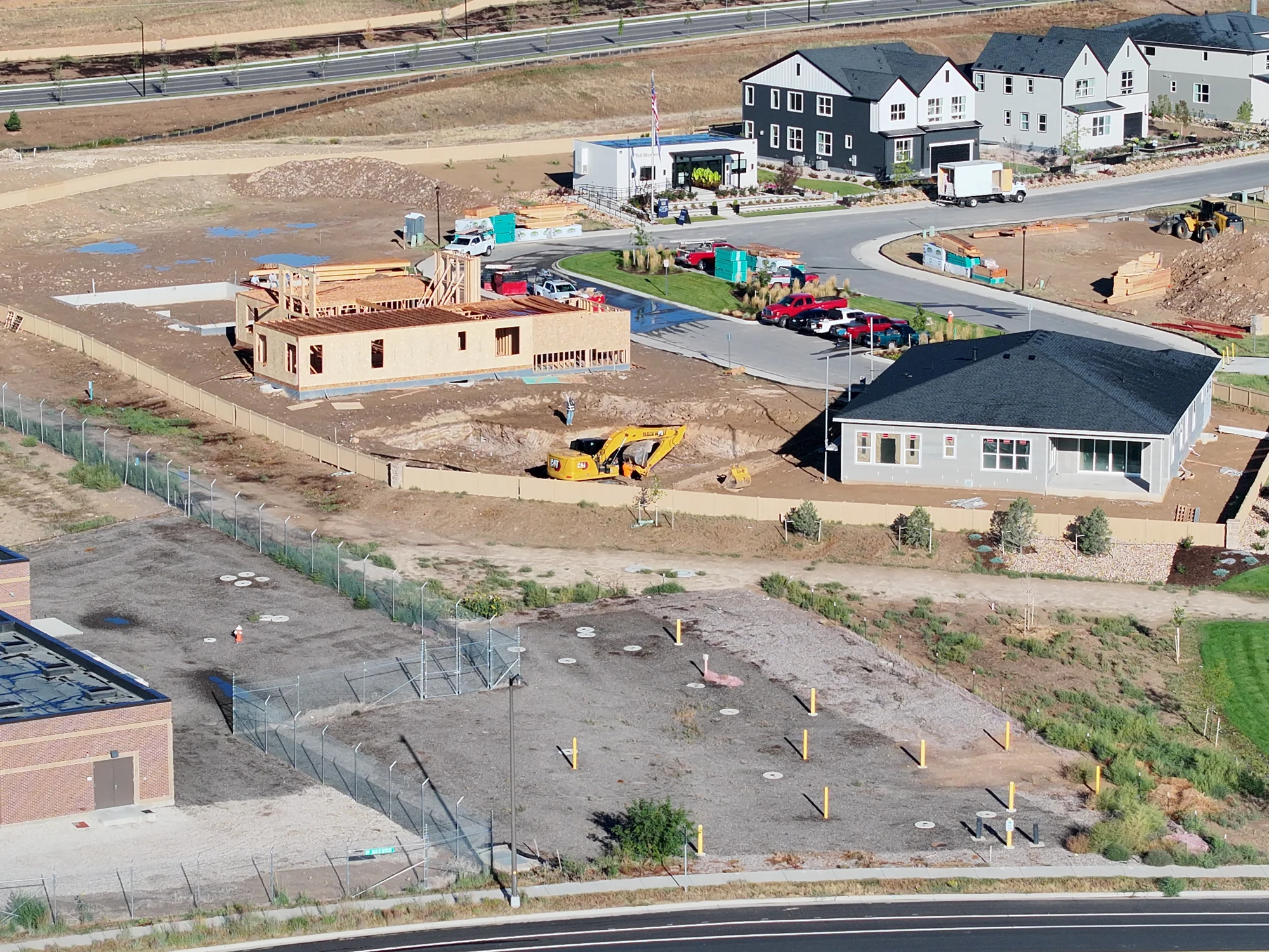 September 21 residential site overview showing active framing, foundations, excavation and the house exterior