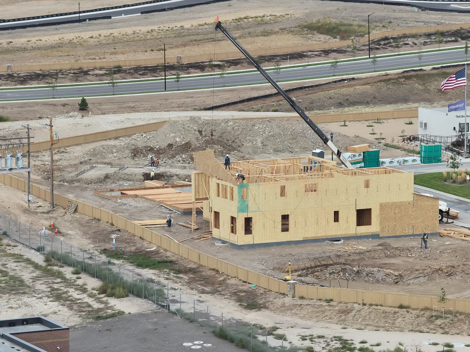 September 28 closer aerial view of wall sheathing, upper framing, crane and staged lumber