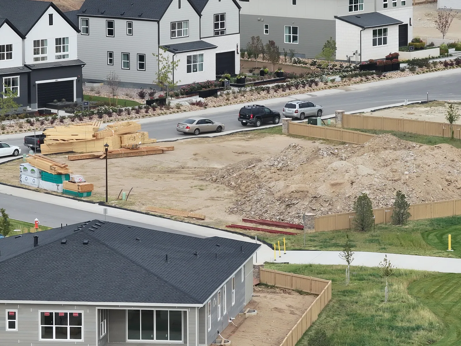 September 28 aerial view of staged lumber and the adjoining earthwork area beside the house