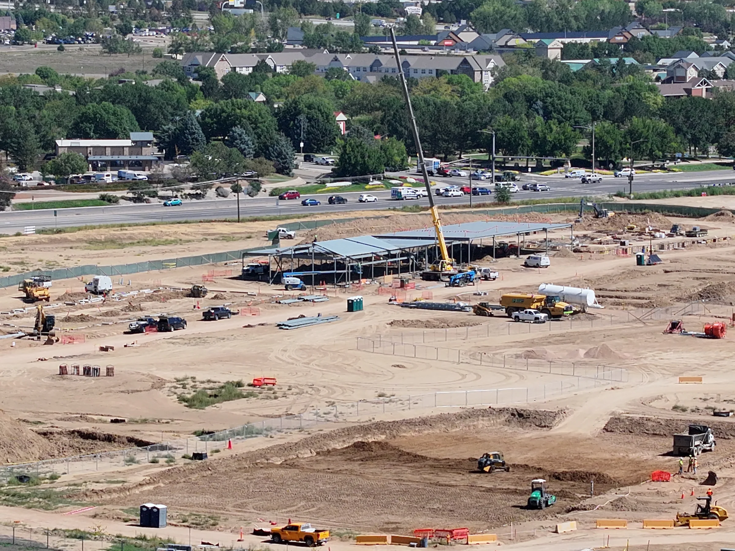 September 9 aerial view of commercial steel building and surrounding construction site