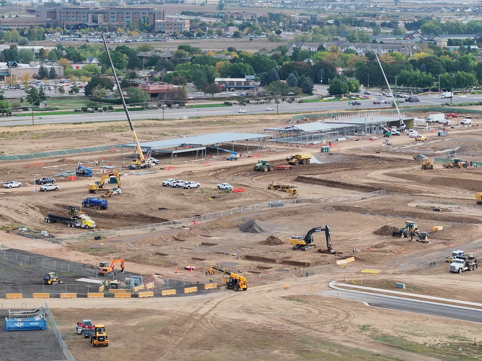 September 28 commercial construction overview showing steel buildings, cranes and active earthwork